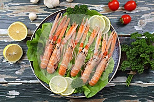 Raw prawns on green salad