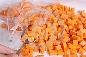 Raw pumpkin cubes in a spoon