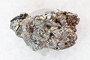 raw pyrite stone on white marble