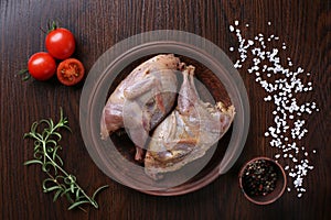 Raw quails ready for cooking on ceramic plate with spices