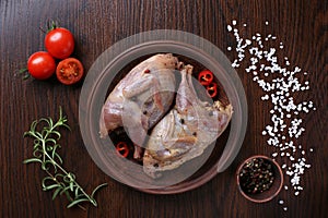 Raw quails ready for cooking on ceramic plate with spices