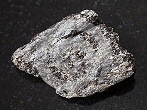 raw quartz-biotite schist stone on dark photo