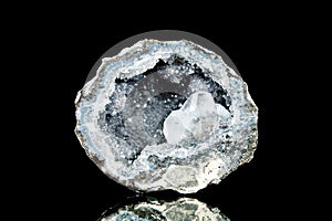 Raw quartz druse or geode mineral stone in front of black background