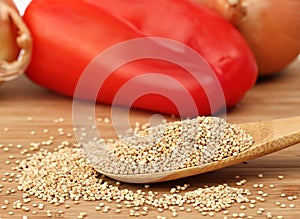 Raw quinoa on a wooden spoon, selective focus.