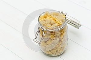 Raw radiatori pasta on a glass jar