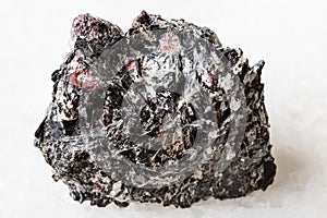 Raw red Garnet crystals in Biotite rock on white photo
