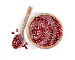 Raw red kidney beans with wooden bowl and spoon isolated on white, top view