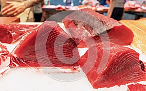 Raw Red Tuna Fish fillet close-up for sashimi or steak at the seafood market.