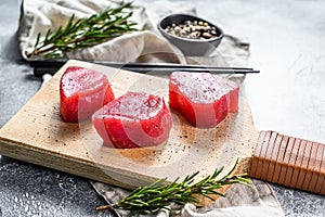 Raw red tuna steak. Gray background. Top view