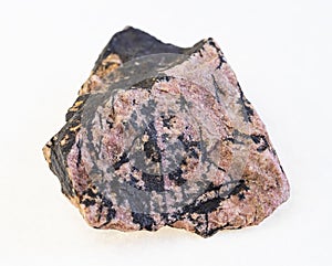 raw rhodonite stone on white