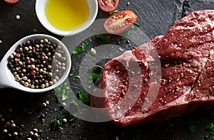 Raw rib-eye steak with seasoning