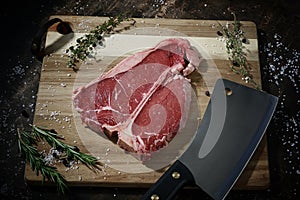 Raw rib eye on wooden bord photo