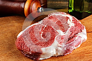 Raw ribeye steak on a cutting board