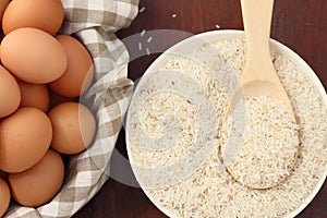 Raw rice with spoon and egg