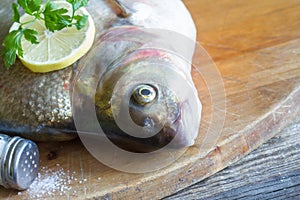 Raw river bream fish on the table in the kitchen