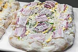 raw Roman Pizza al taglio with egg and cheese and ham photo