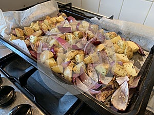 Raw Root vegetables roasted on a baking tray landscape