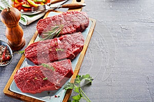 Raw rump steak cut in slices on cutting board