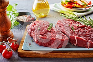 Raw rump steak prepared on cutting board