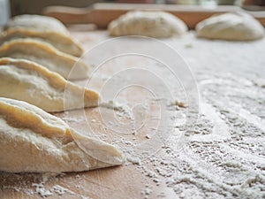 Raw pirozhki with cabbage in the cooking process.