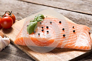 Raw salmon fillet with herbs