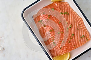 Raw salmon fillet with rosemary and lemon. Norwegian seafood cuisine. Humpback fillet