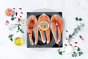 Raw salmon fish fillet with fresh herbs photo