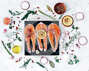 Raw salmon fish fillet with fresh herbs photo