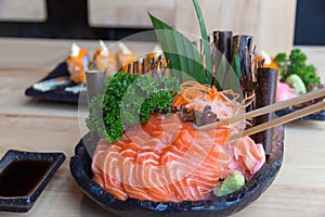 Raw salmon sashimi on black plate - Japanese food