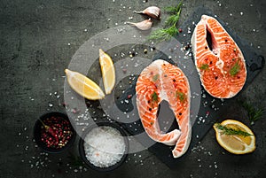 Raw salmon steak with food ingredients.