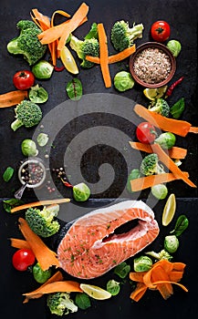Raw salmon steak and ingredients for cooking.