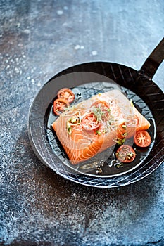 Raw salmon steak in a skillet or pan