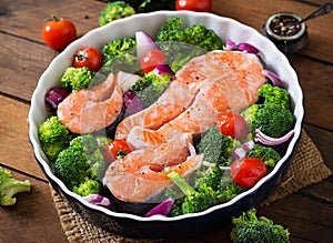 Raw salmon steak and vegetables