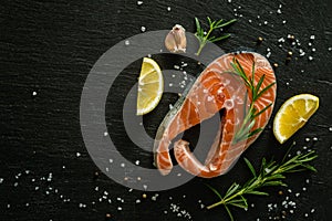 Raw salmon steaks on rustic background