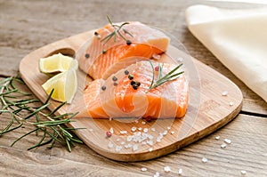 Raw salmon steaks on the wooden board