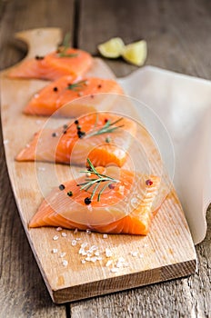 Raw salmon steaks on the wooden board