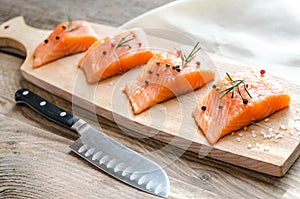 Raw salmon steaks on the wooden board