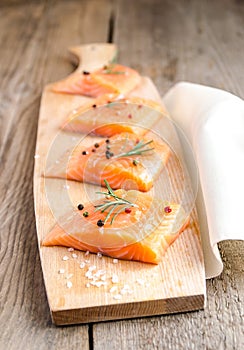 Raw salmon steaks on the wooden board