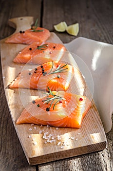 Raw salmon steaks on the wooden board