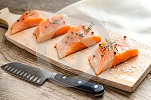 Raw salmon steaks on the wooden board