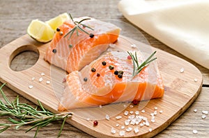 Raw salmon steaks on the wooden board