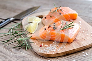 Raw salmon steaks on the wooden board