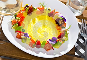 Raw salmon tartare with fruits, vegetables, flowers