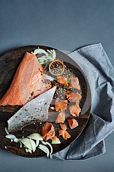 Raw salmon on wooden plate