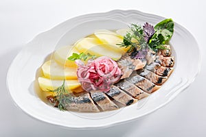 Raw Salted Soused Herring with Onions and Potato Isolated photo