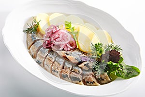 Raw Salted Soused Herring with Onions and Potato Isolated photo