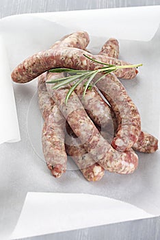 Raw sausages chipolata with herbs