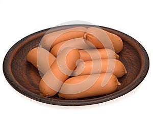 Raw sausages in a plate isolated on white background