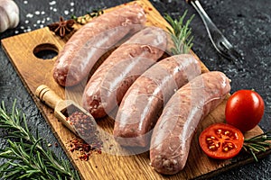 raw sausages with spices and rosemary, Food recipe background. Close up