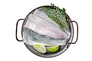 Raw Sea Bass fillet, Labrax fish with herbs and lime. Isolated, white background. photo